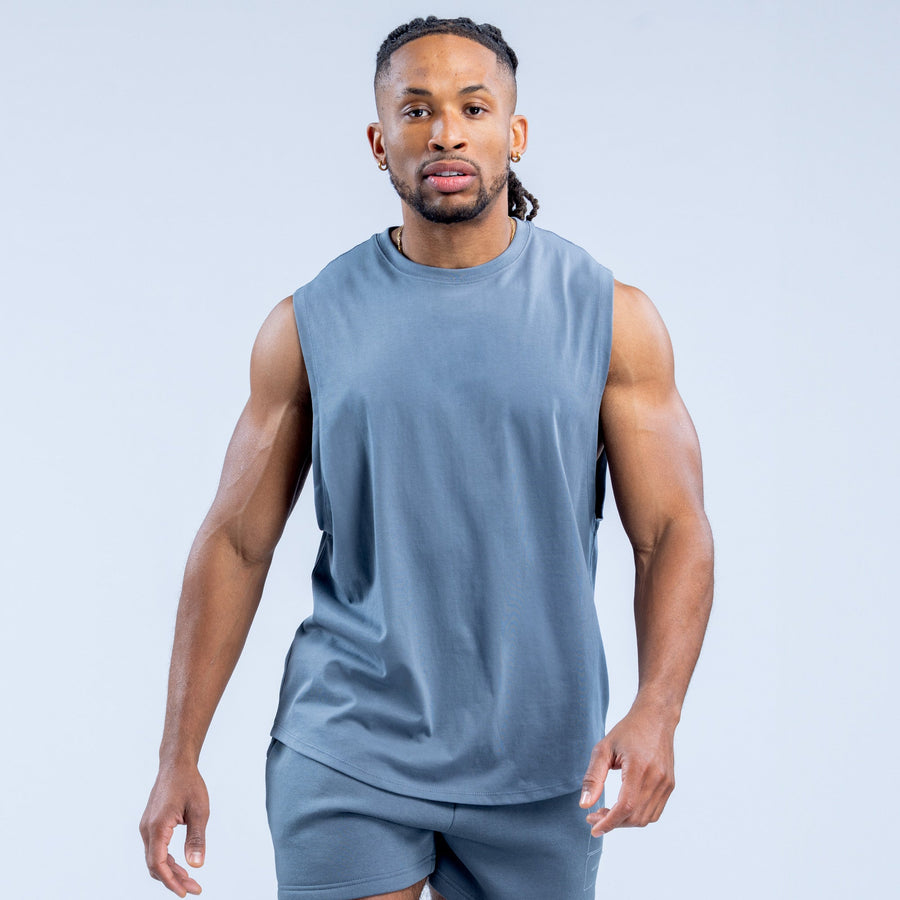 Men's blue sleeveless graphic tank top, front view with solid printed-less chest