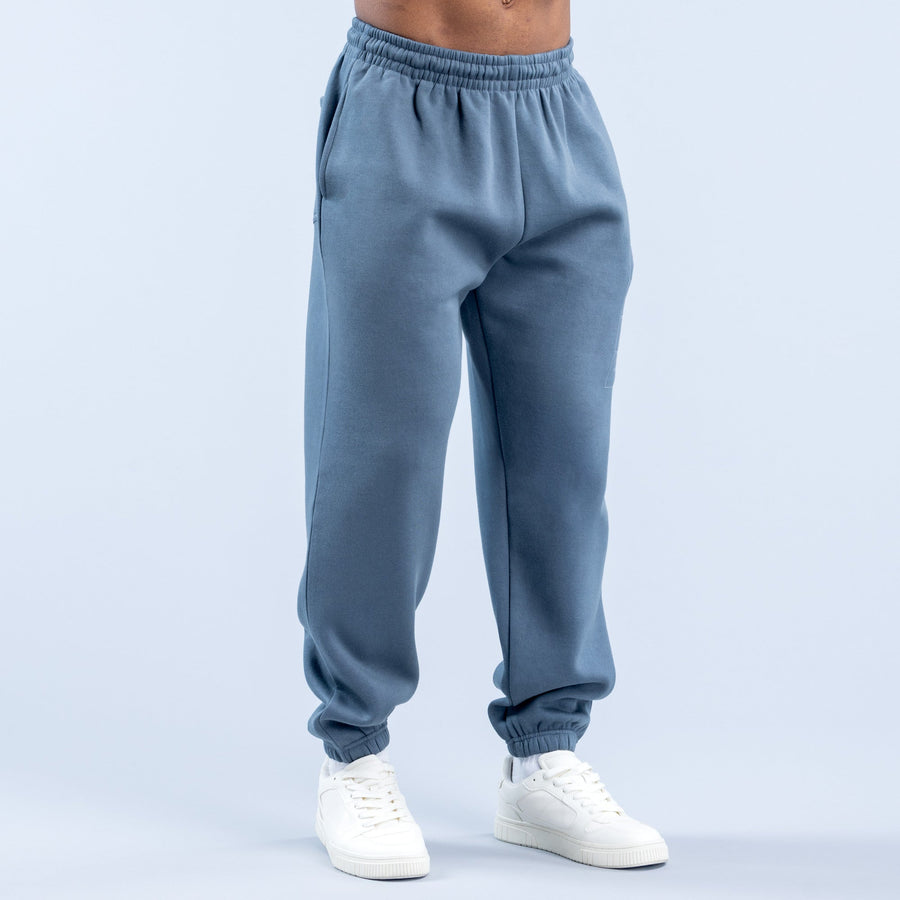 Blue jogger pants with elastic waistband and cuffed hems, front seam details