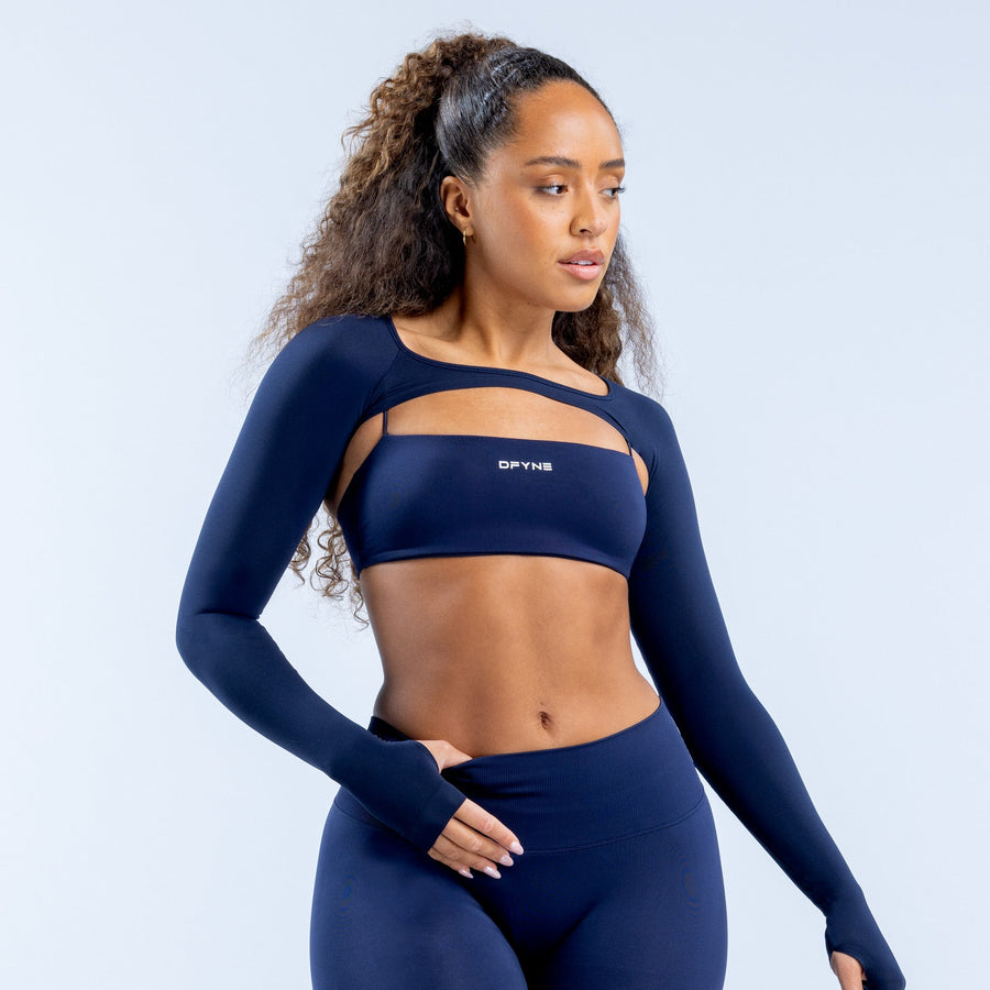 Navy long-sleeve shrug with cutout collar detail and cropped waist fit
