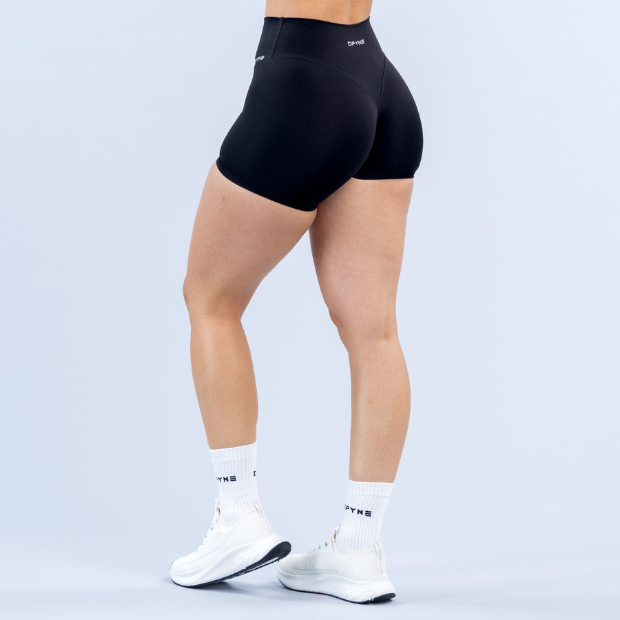 Women's black 4.5-inch biker shorts, back view, seamless fabric, small logo