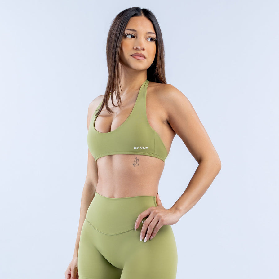 Green halter bra with racerback cutout and supportive front coverage