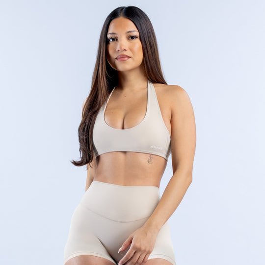Backless halter bra in light cream with smooth molded cups and thin straps