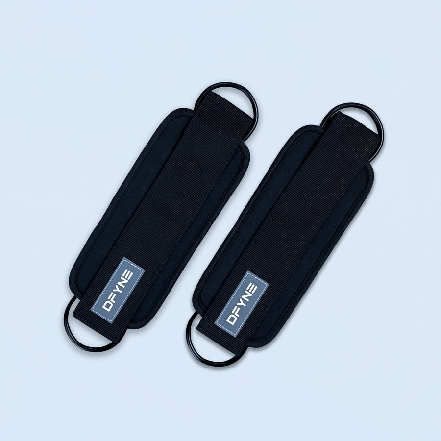 Black fabric ankle straps with curved buckle loops and printed logo patch
