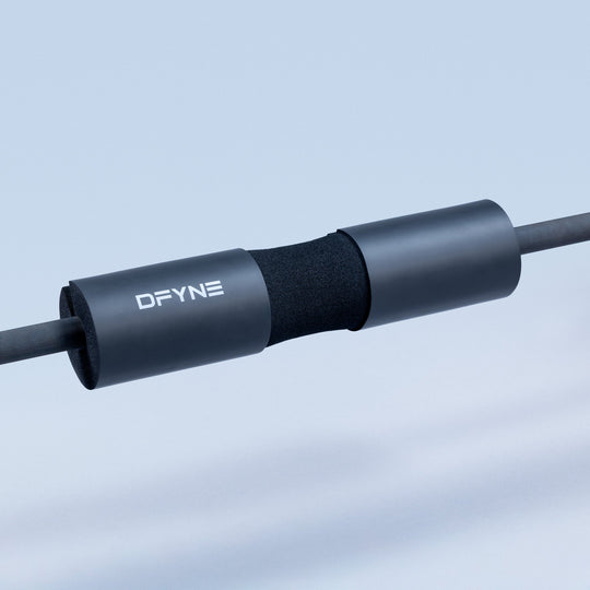 DFYNE black foam barbell pad with textured sleeve on metal bar