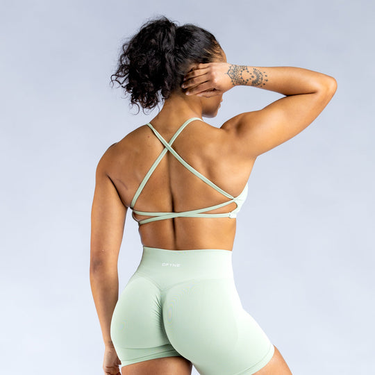 Mint green backless sports bra from behind, crisscross open-back straps