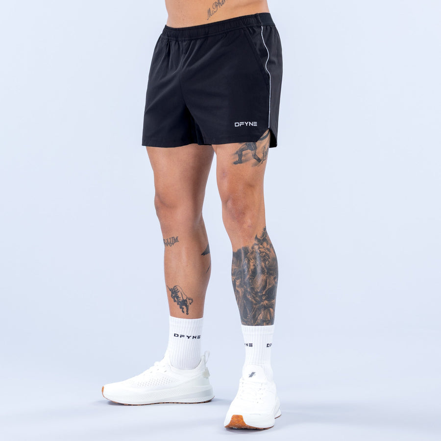 Men's black 4-inch training shorts with elastic waistband and white side piping