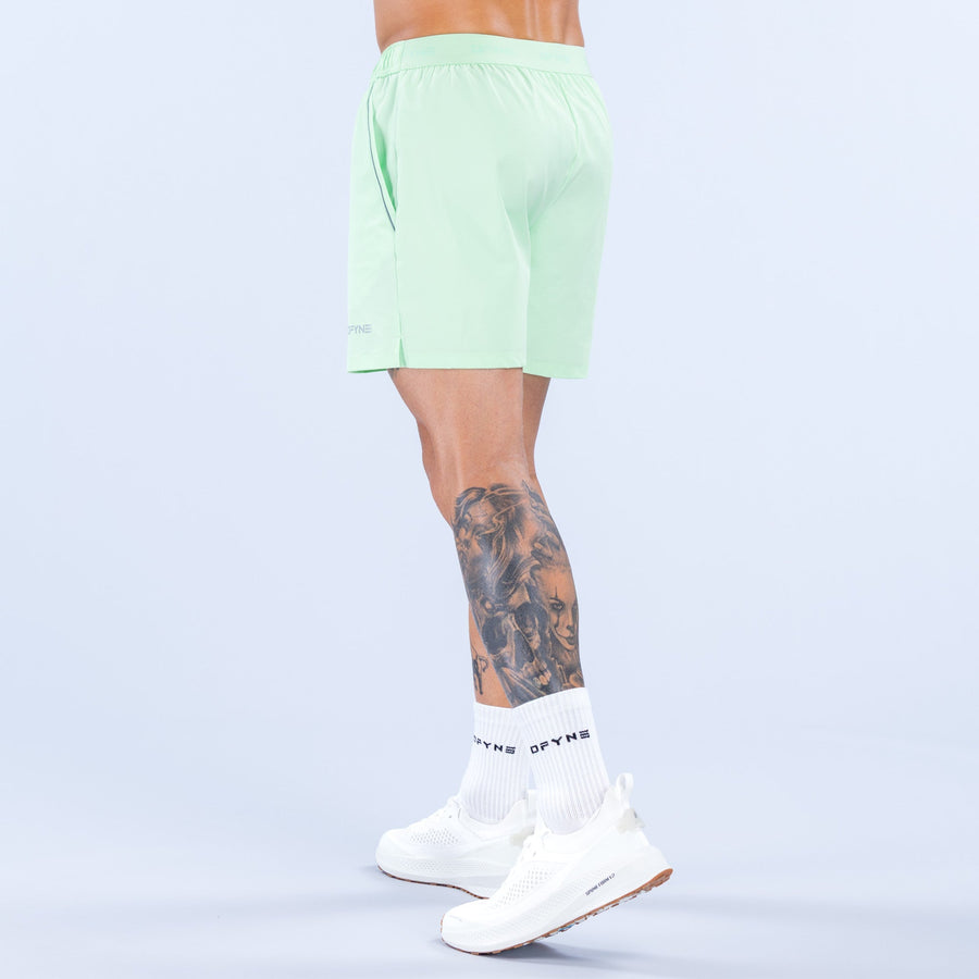 Light green training shorts, back view with elastic waistband and 6-inch inseam
