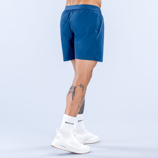 Men's blue training shorts, back view, elastic waistband, logo at hem, 6 in inseam