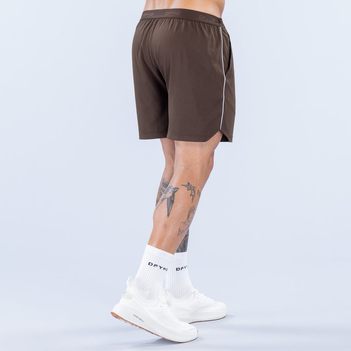 6-inch training shorts, dark brown, DFYNS logo at hem, elastic waistband