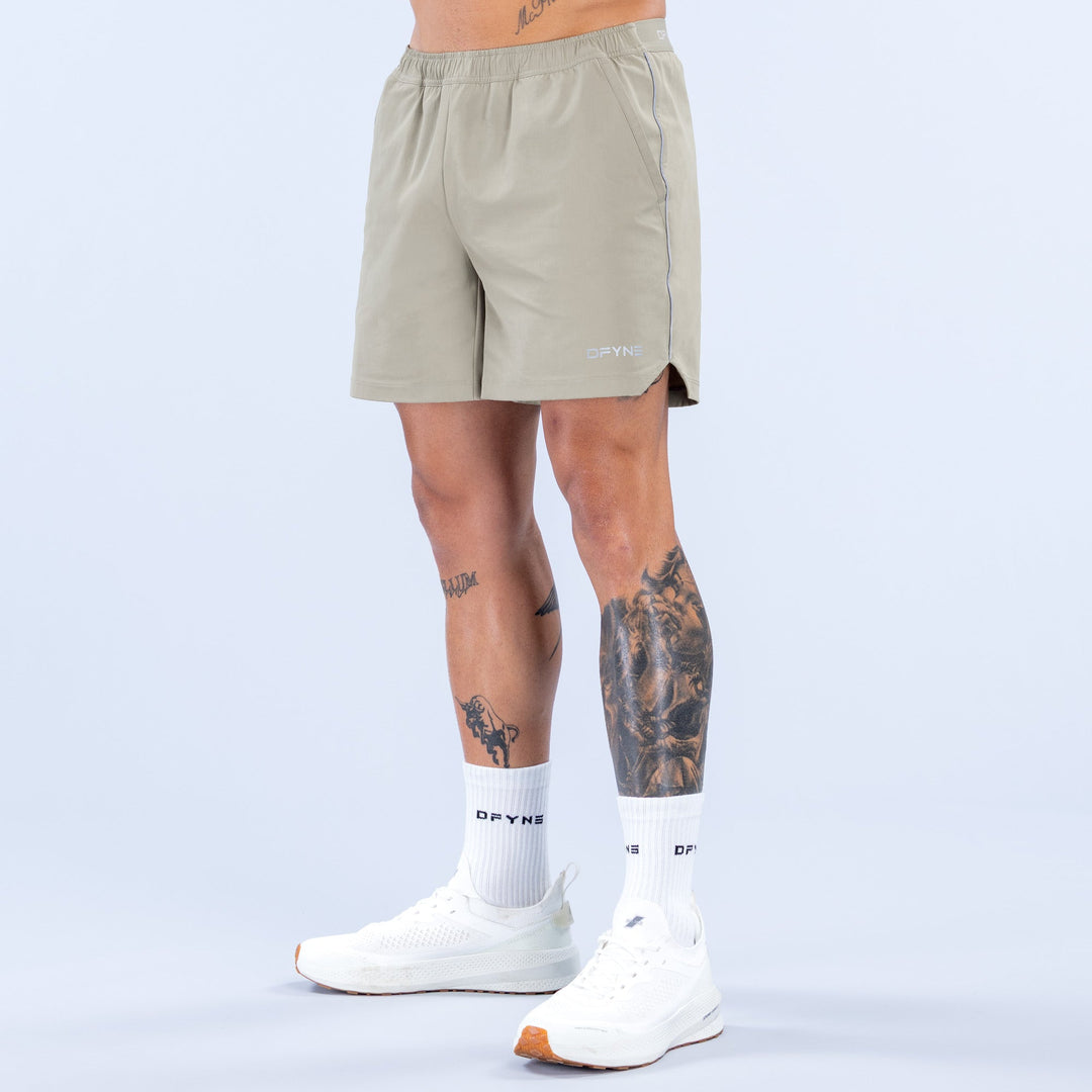 Olive 6-inch training shorts with elastic waistband and side seam accents