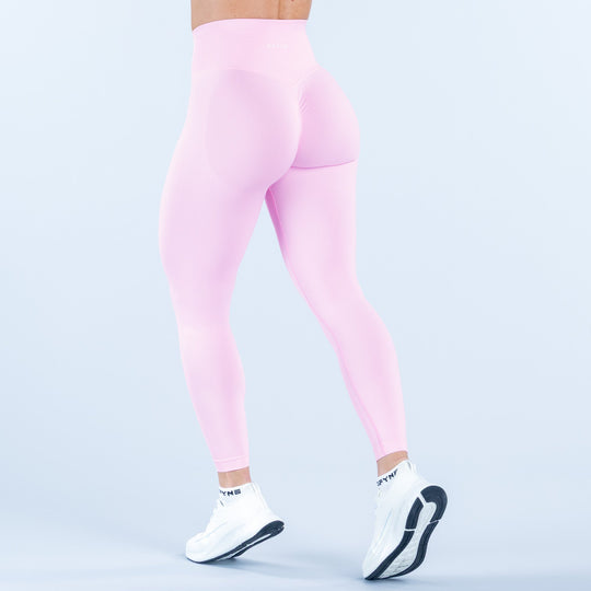 Light pink high-waist leggings with back curve detail, three-quarter view