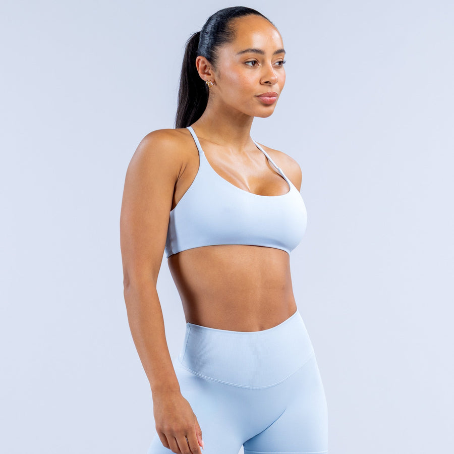 Light blue sports bra with wide underband and slim adjustable straps