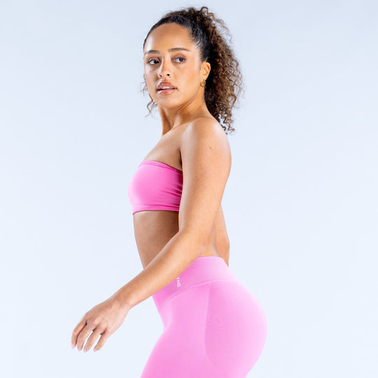 Pink bandeau top with open sides and matching high-waist waistband, side view