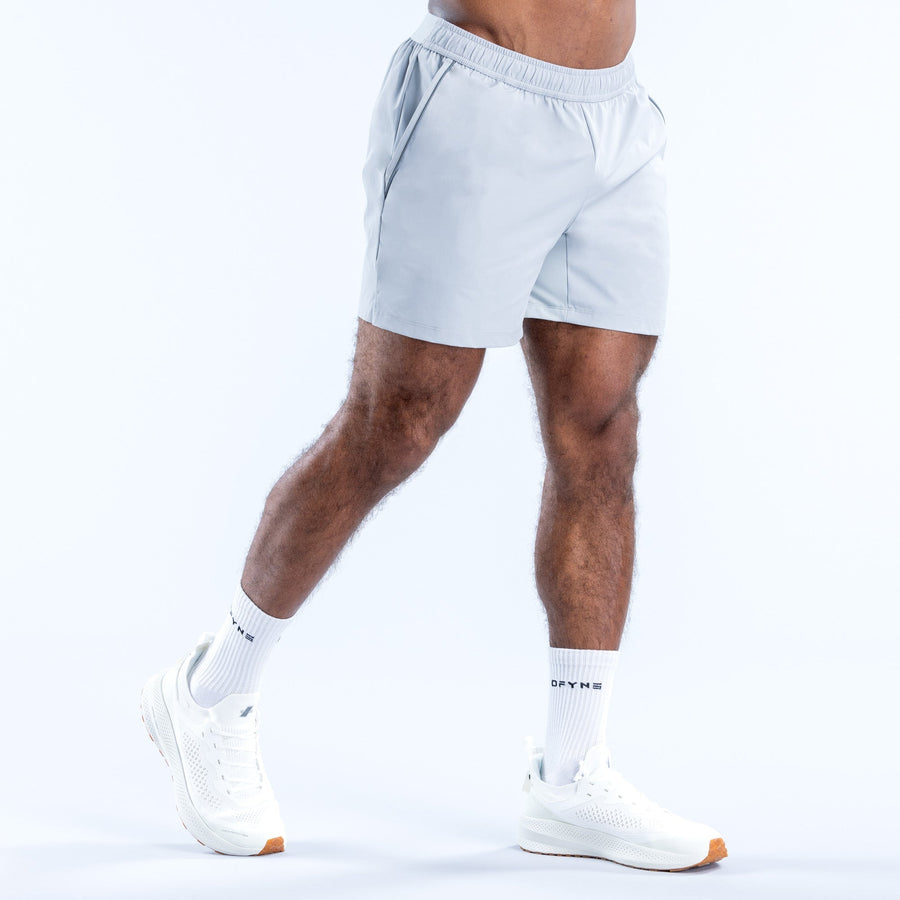 Light blue training shorts, side view, elastic waistband and logo at hem