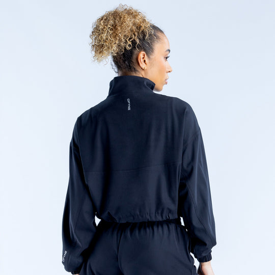 Black cropped zip-up jacket, back view, high collar with quarter zip, elastic cuffs