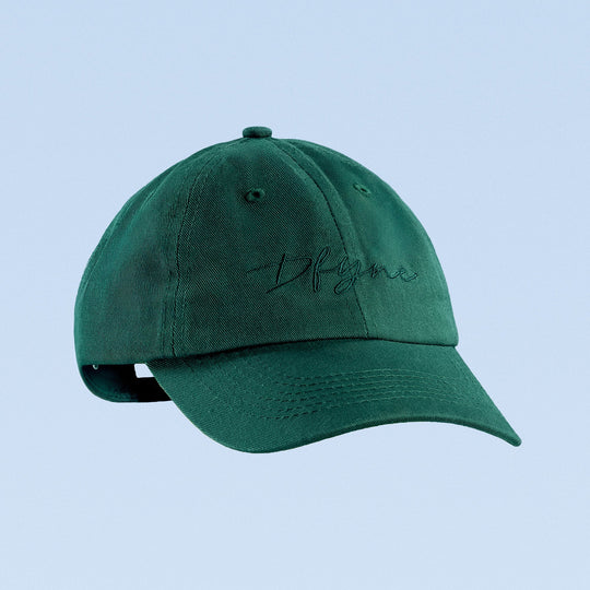 Green baseball cap with cursive embroidered logo, curved brim
