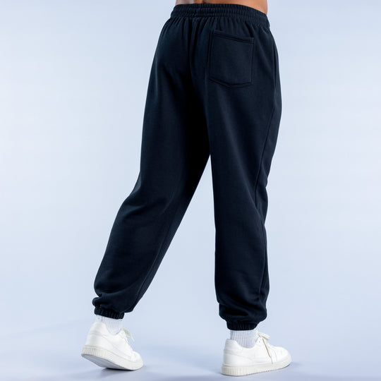 Dark cuffed jogger pants, side seam pockets and elastic cuffs at ankles