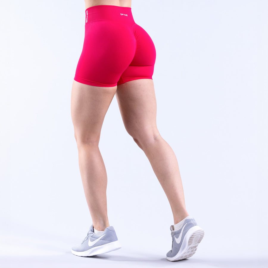 4.5-inch bright pink athletic shorts, back view with seam detail.