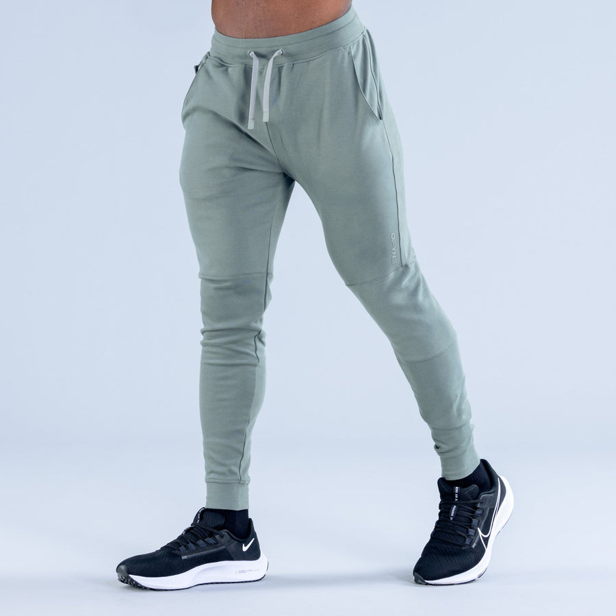 Sage green tapered jogger pants with drawstring waist and cuffed ankles