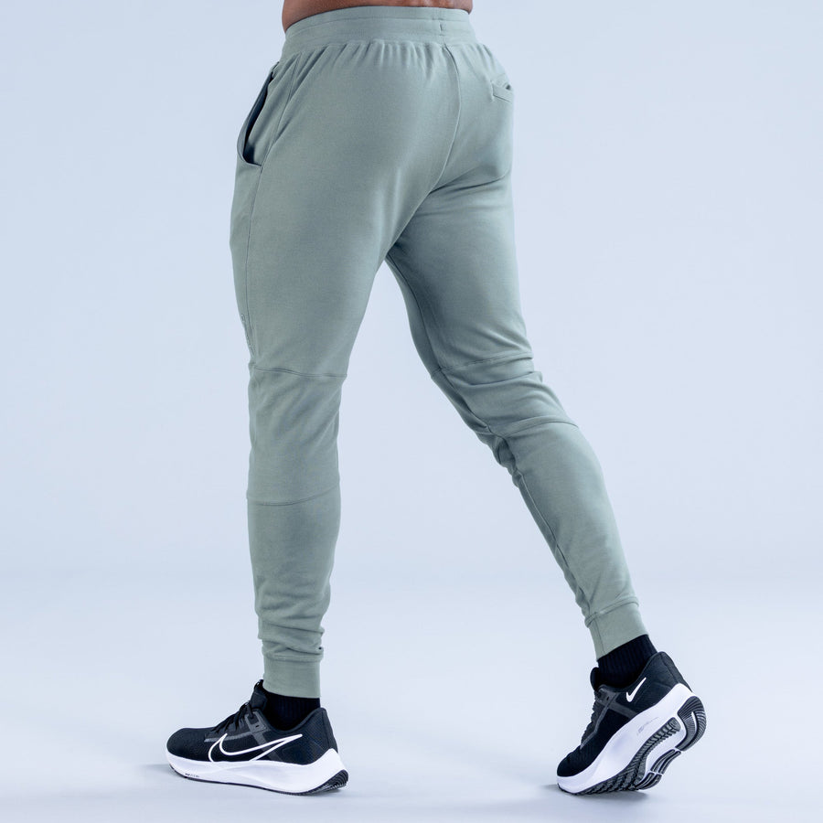 Sage green tapered jogger pants with back pocket and ribbed ankle cuffs