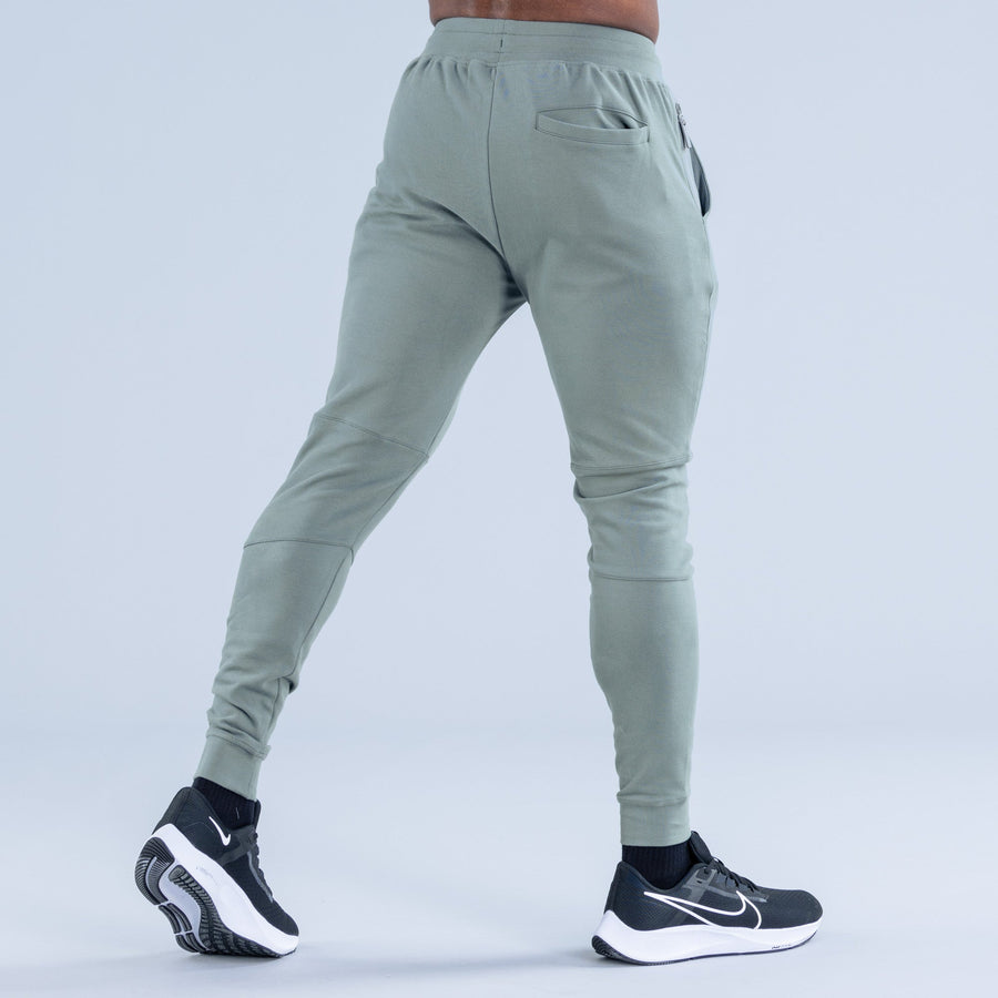 Sage green tapered jogger pants from behind, drawstring waist and back pocket