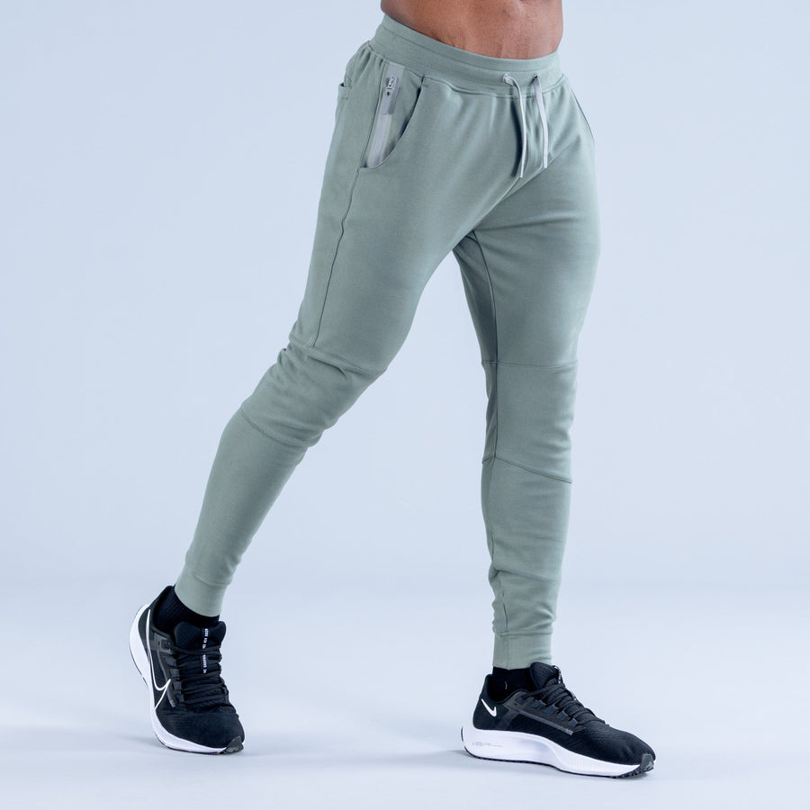 Sage green tapered jogger pants side view with drawstring waist and side pocket