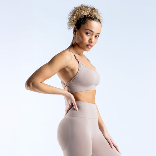 Taupe backless sports bra with thin straps and fitted elastic band