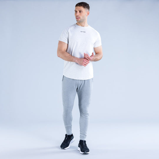 Light gray tapered jogger pants on model, front view with drawstring and slim legs