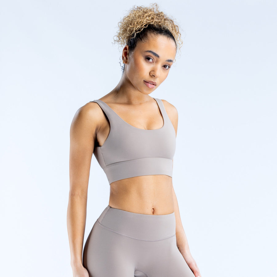 Light gray sports bra with scoop front and supportive band under bust