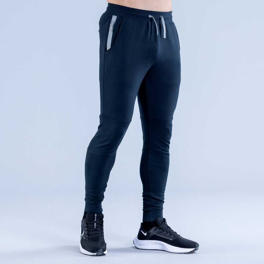 Dark navy tapered jogger pants with drawstring waist and side seams
