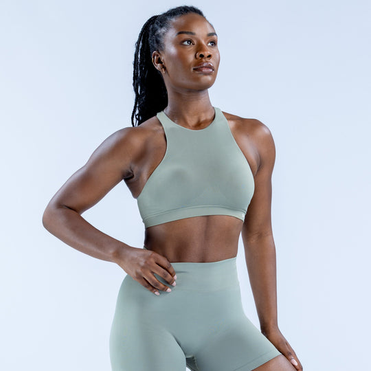 Sage green high-neck racerback sports bra with smooth fitted look