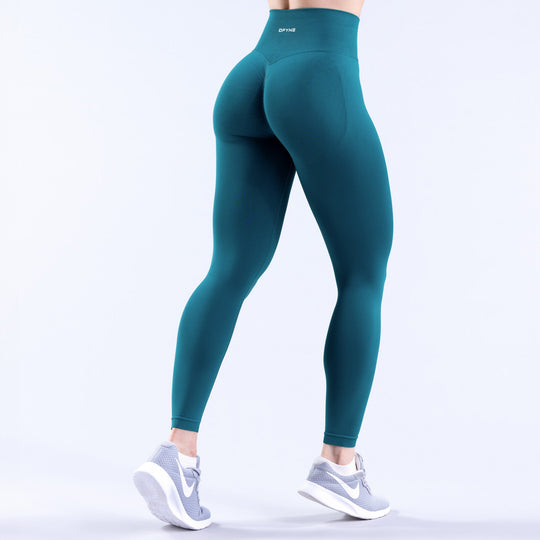 Teal high-waist leggings with curved back yoke detail and fitted legs