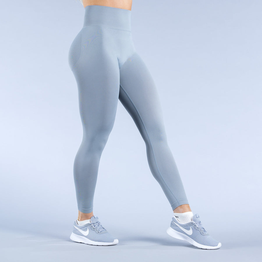 Sky-blue leggings, back view with tapered ankle cuffs and logo accents