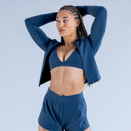 Blue zip-front hoodie and matching shorts set, open front over sports bra