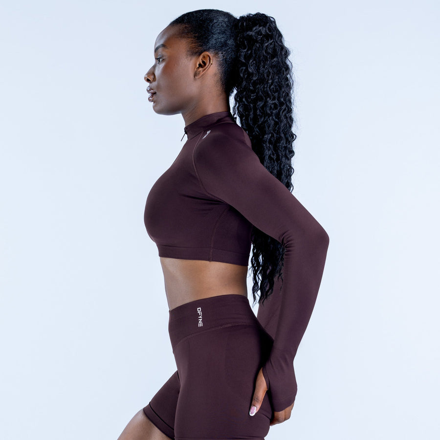 Maroon fitted crop jacket side view with quarter zip neck, long sleeves