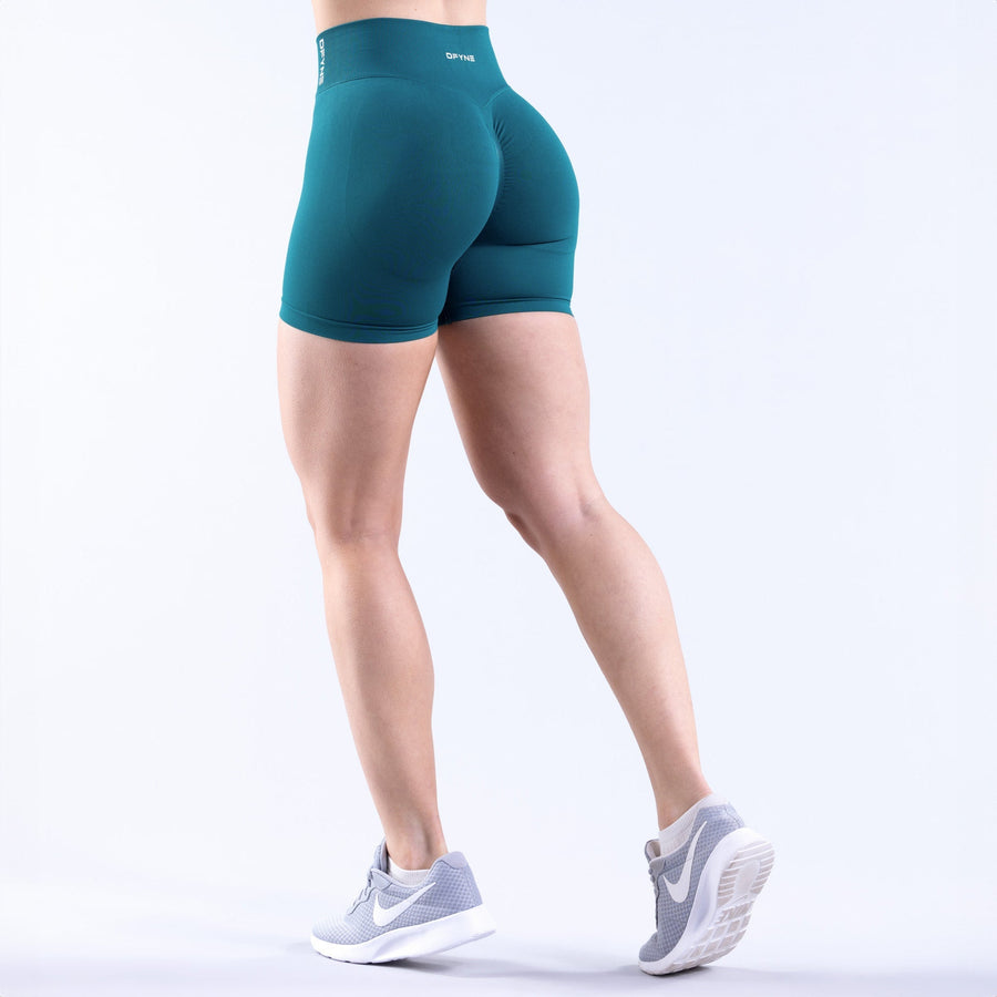 Women's teal 4.5-in athletic shorts, back view with contoured seams