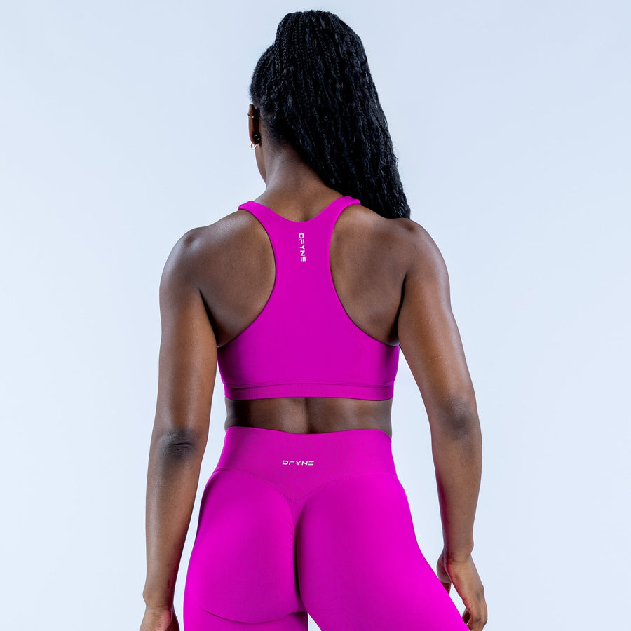 Women's magenta racerback sports bra, back view with high neckline