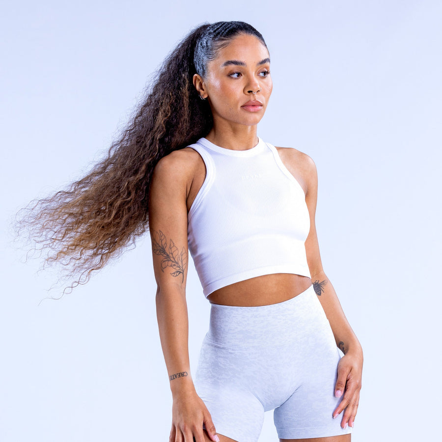 White racerback crop tank top with high neck, sleeveless athletic stretch
