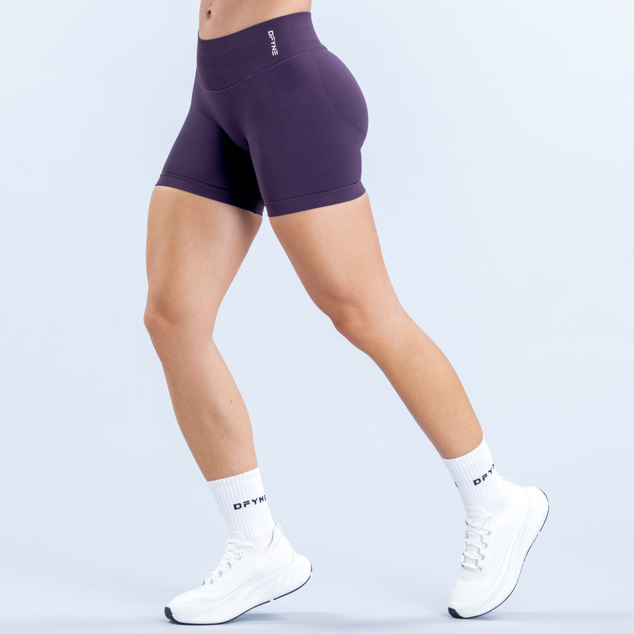 Purple 4.5-inch fitted shorts with a high-rise waistband, shown from the side.