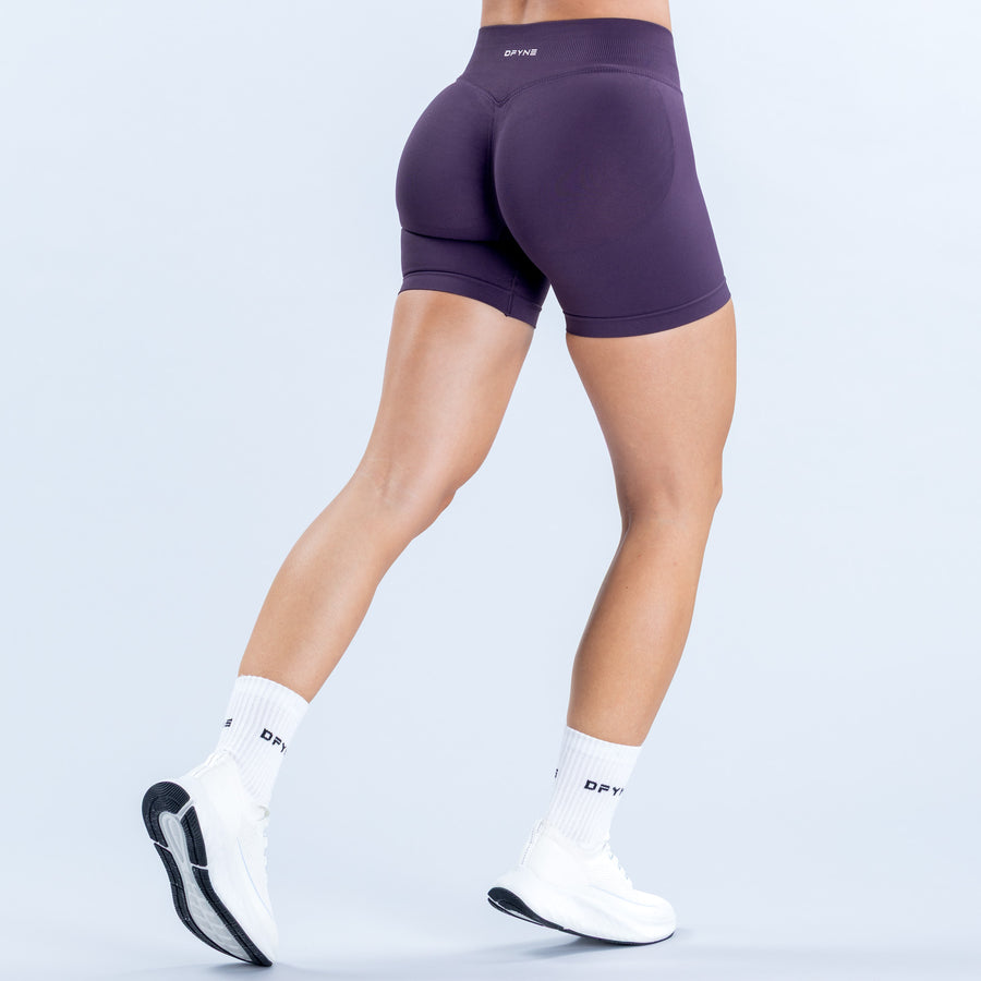 Purple 4.5-inch fitted shorts with a high-rise waistband, shown from the back.