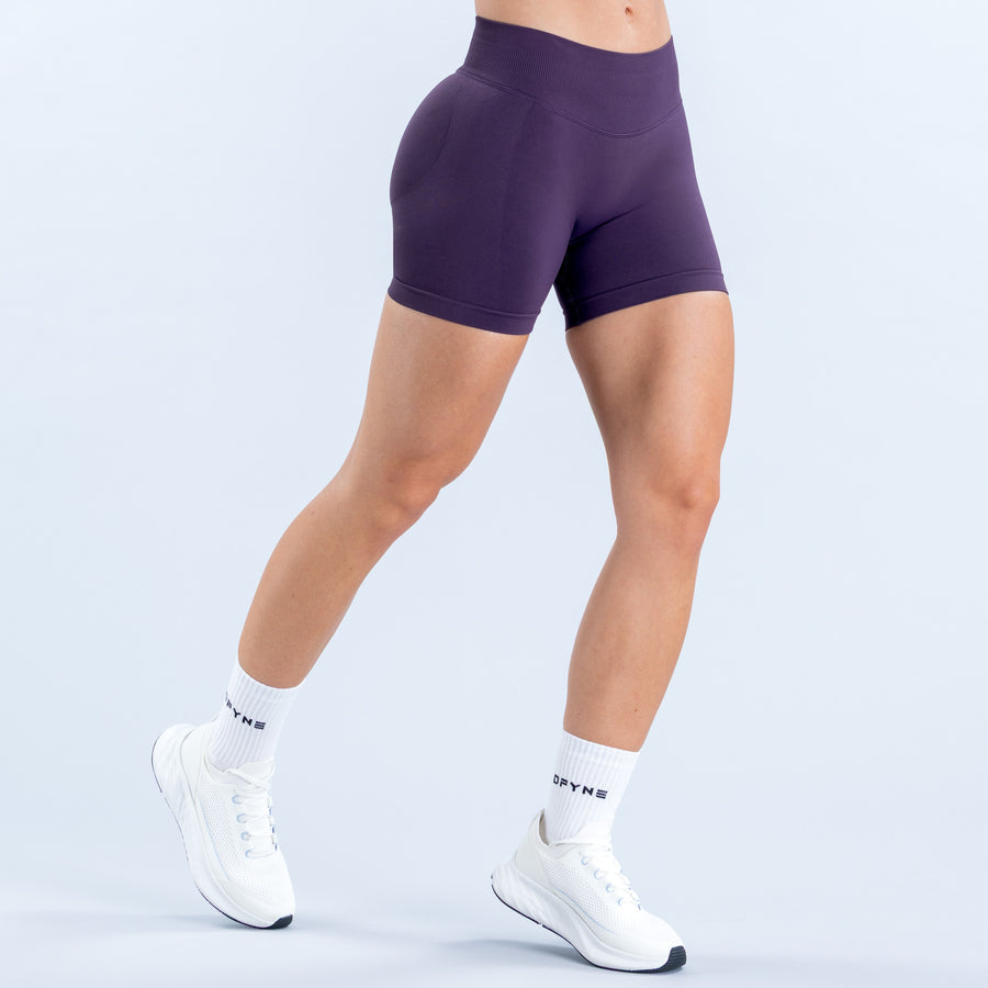 Purple 4.5-inch fitted shorts with a high-rise waistband, shown from the front.