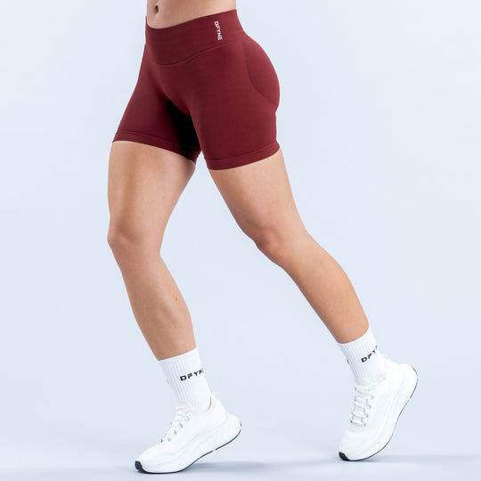 Burgundy 4.5-inch athletic shorts with a high waist, shown from the side