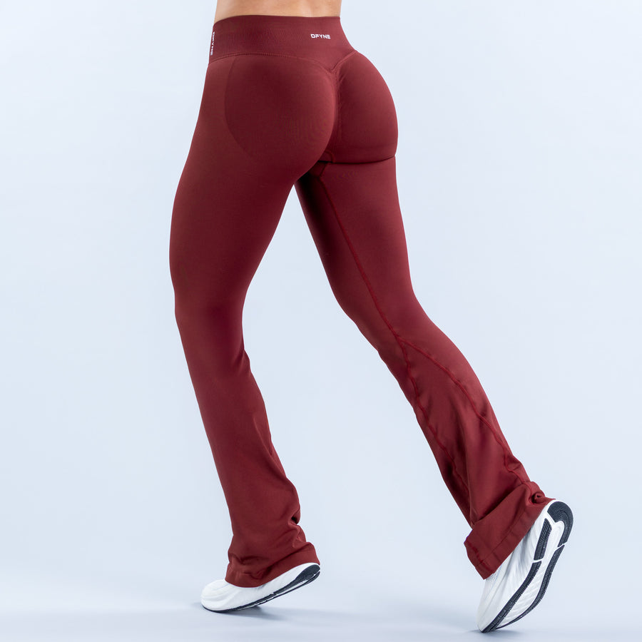 Burgundy flared leggings, angled rear view with long flared hems