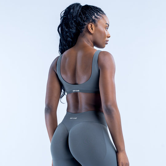 Scoop-back sports bra with racerback straps and elastic hem band, dark gray