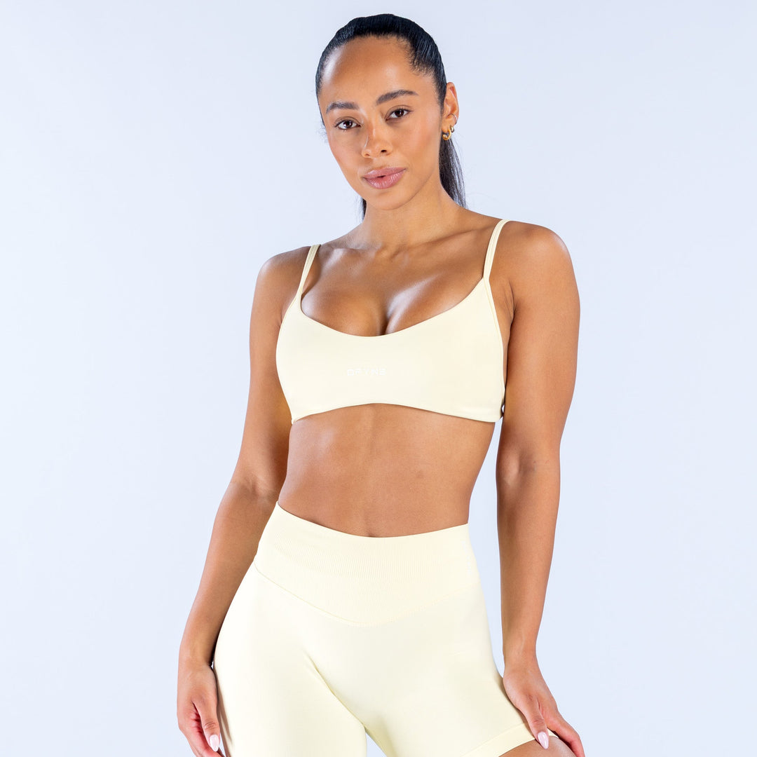 Cream scoop-neck bralette with thin straps and wide underband