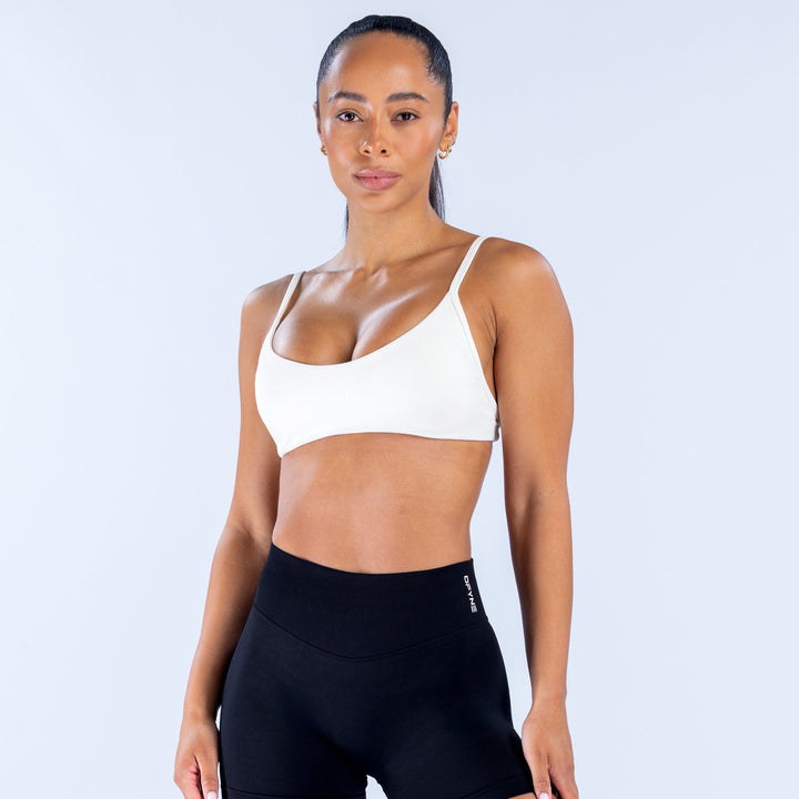 White scoop-neck sports bra with thin straps