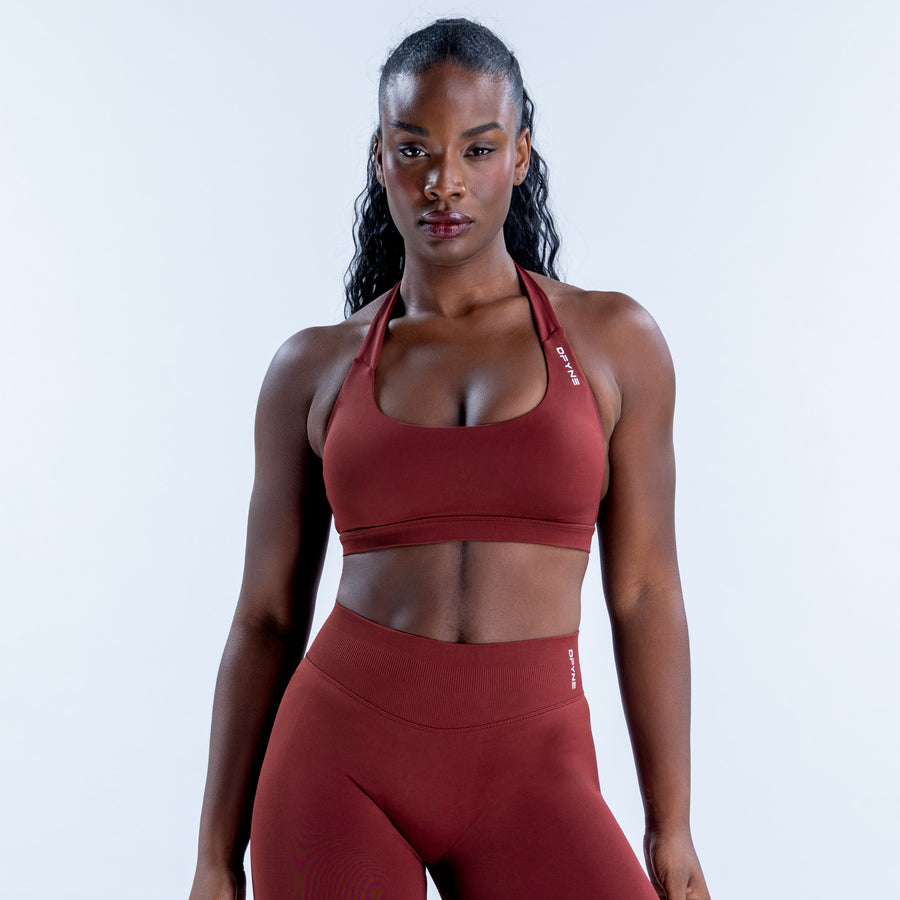 Burgundy Impact Sports Bra with a scoop neckline and halter straps, shown from the front