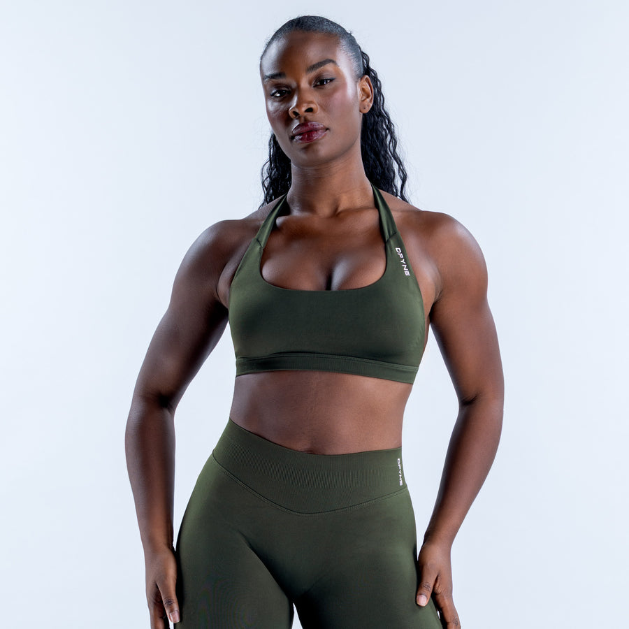 Dark green sports bra with a scoop neckline and wide underband, shown from the front