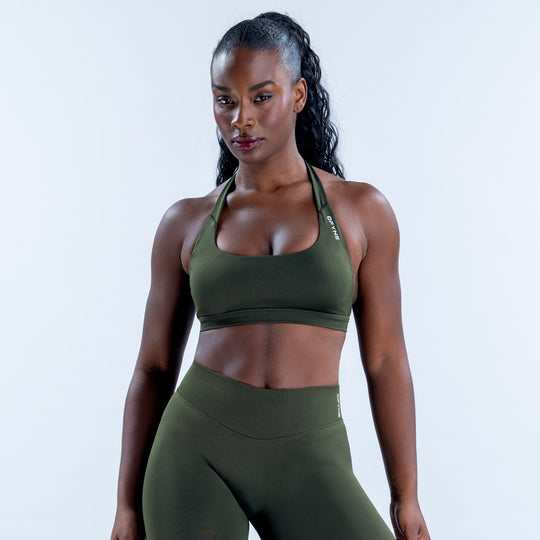 Front view of a dark green sports bra with a scoop neck and wide underband