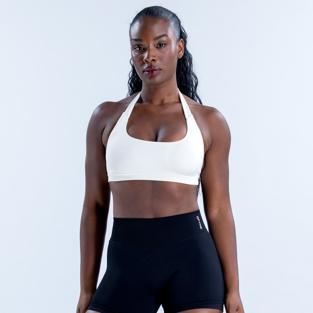 White halter sports bra with a scoop neckline and wide underband